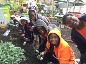 So What Else children doing volunteer work in a community garden