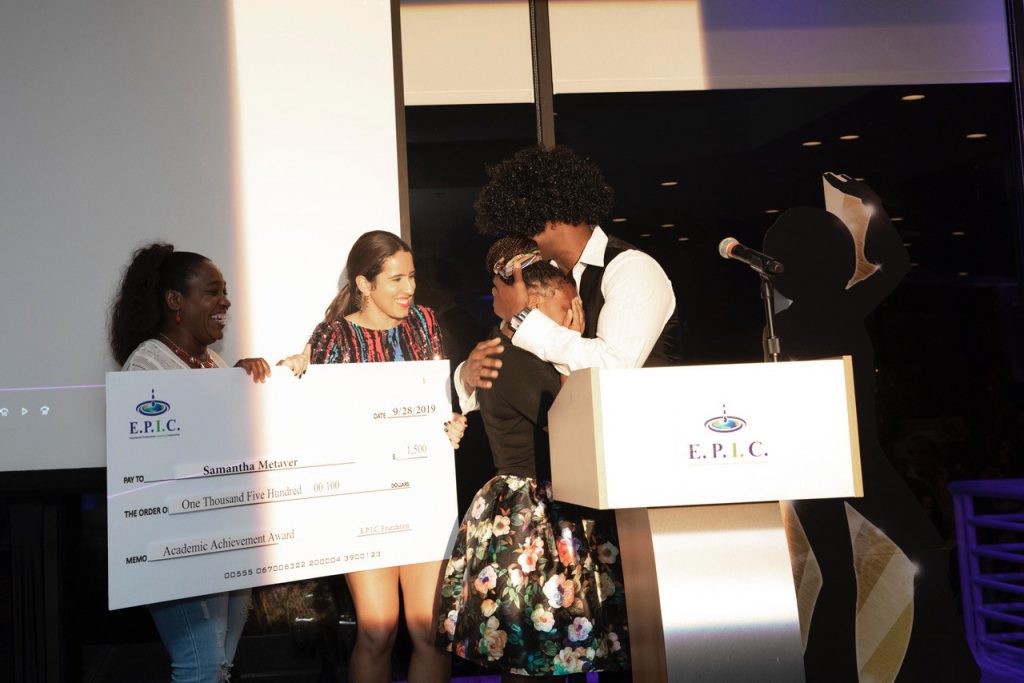 student cries on receiving a scholarship check from AJ Donaldson of the EPIC Foundation