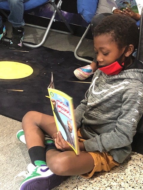 Urban Scholars Academy youngster reads book