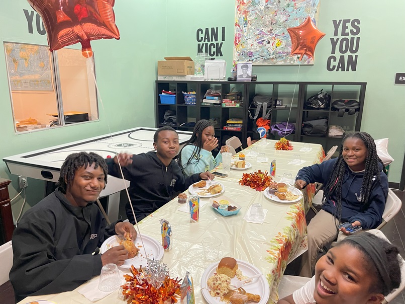 Young people share a meal at the Wooten Center