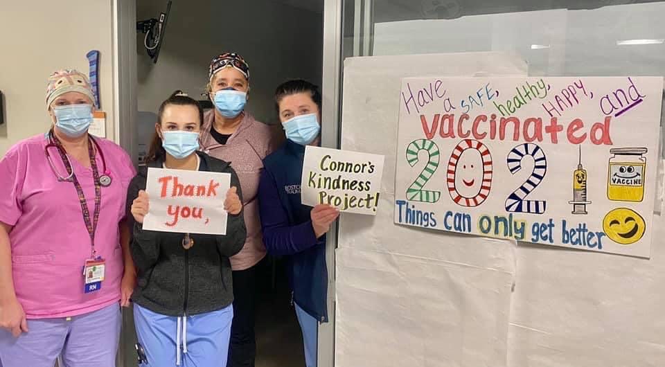 Health care workers hold signs thanking Connor's Kindness Project