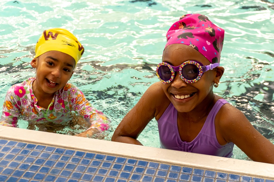 two smiling girls swimming