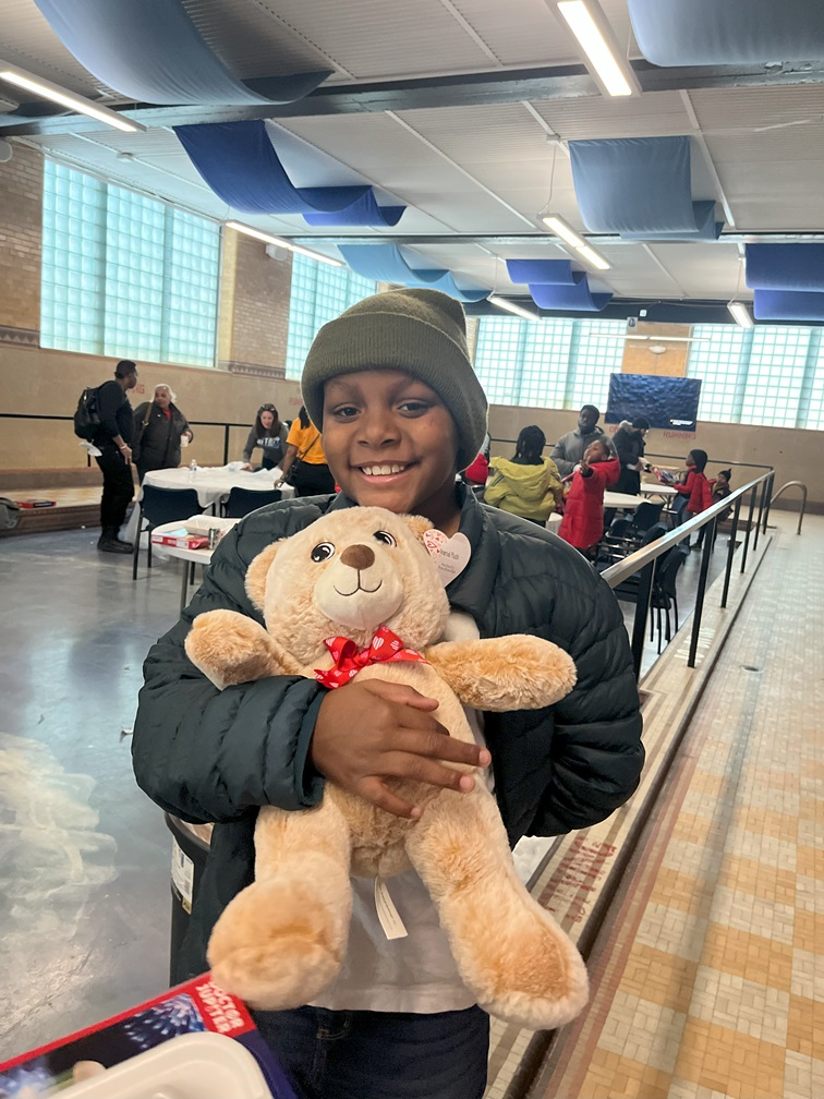 FR1ENDS of the CH1LDREN Detroit youngster hugs teddy bear