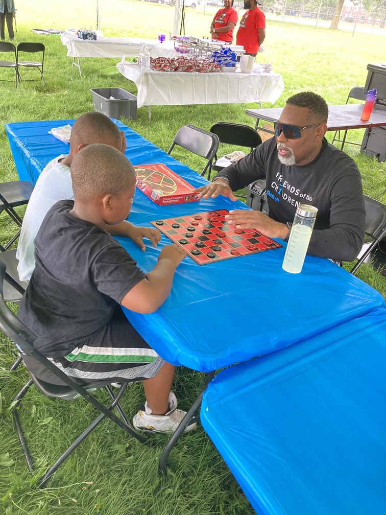 FR1ENDS of the CH1LDREN Detroit mentor and mentees play checkers