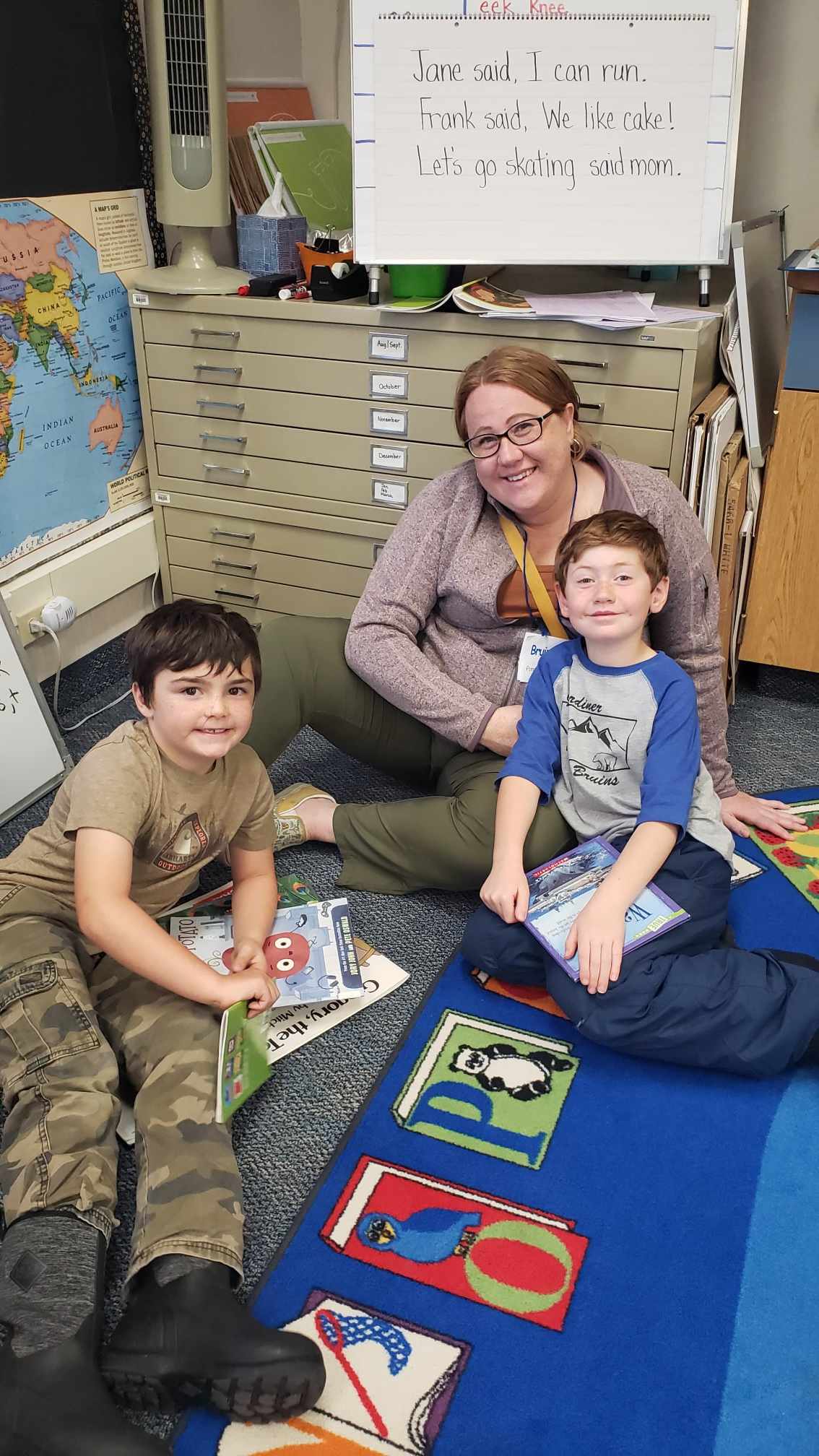 reading corner with young boys, books, teacher