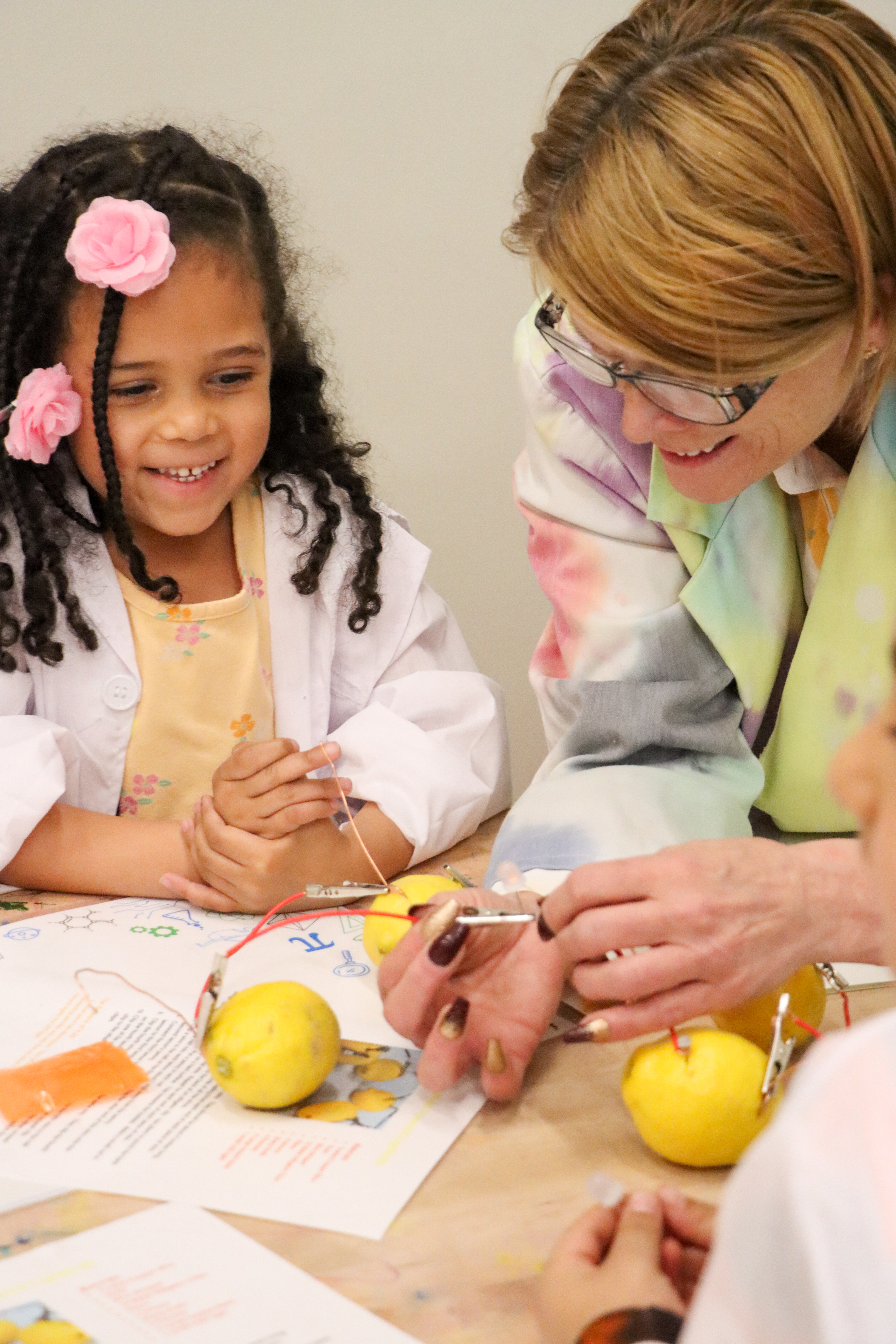 Happy girl mother play, lemons, SPARK