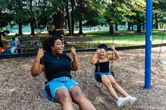 Big Brothers Big Sisters of Kentuckiana Big and Little sisters swing together in the park