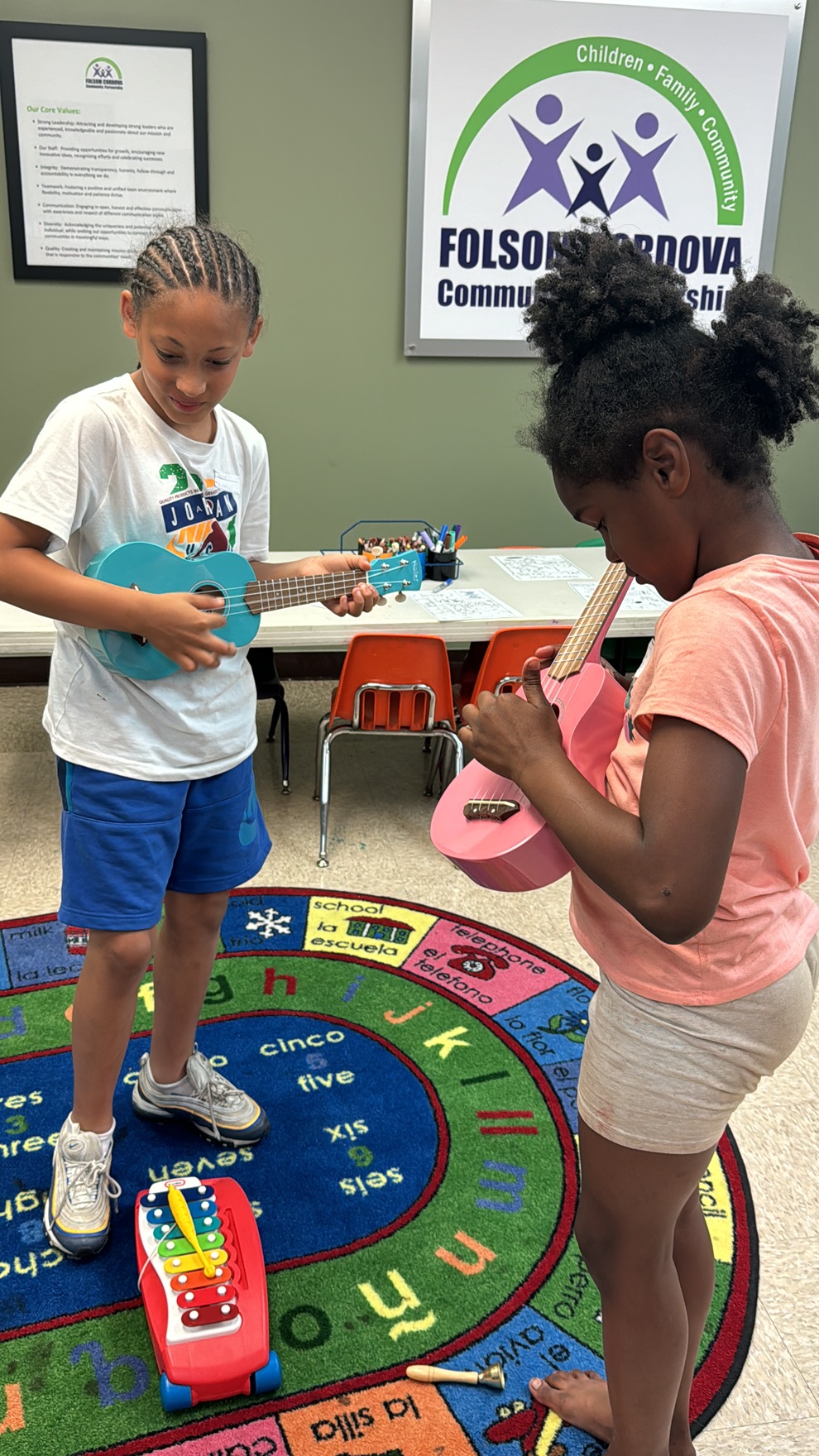 Folsom Cordova Community Partnership young participants play toy guitars