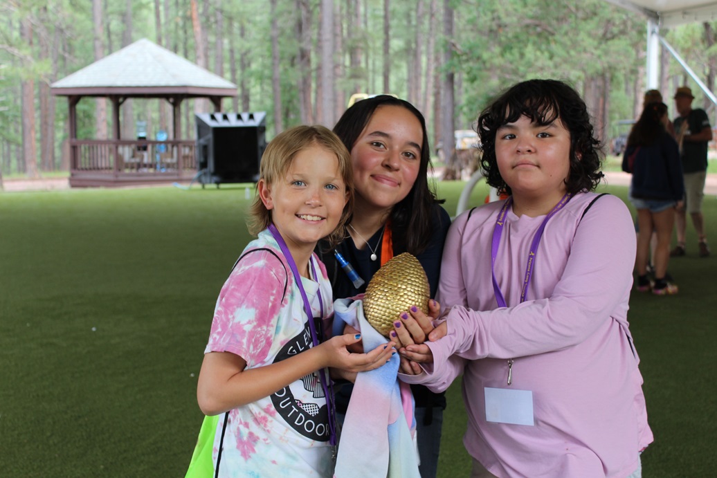 Arizona Camp Sunrise and Sidekicks Southwest Kids Cancer Foundation group photo, three girls hold "golden egg," treasure hunt