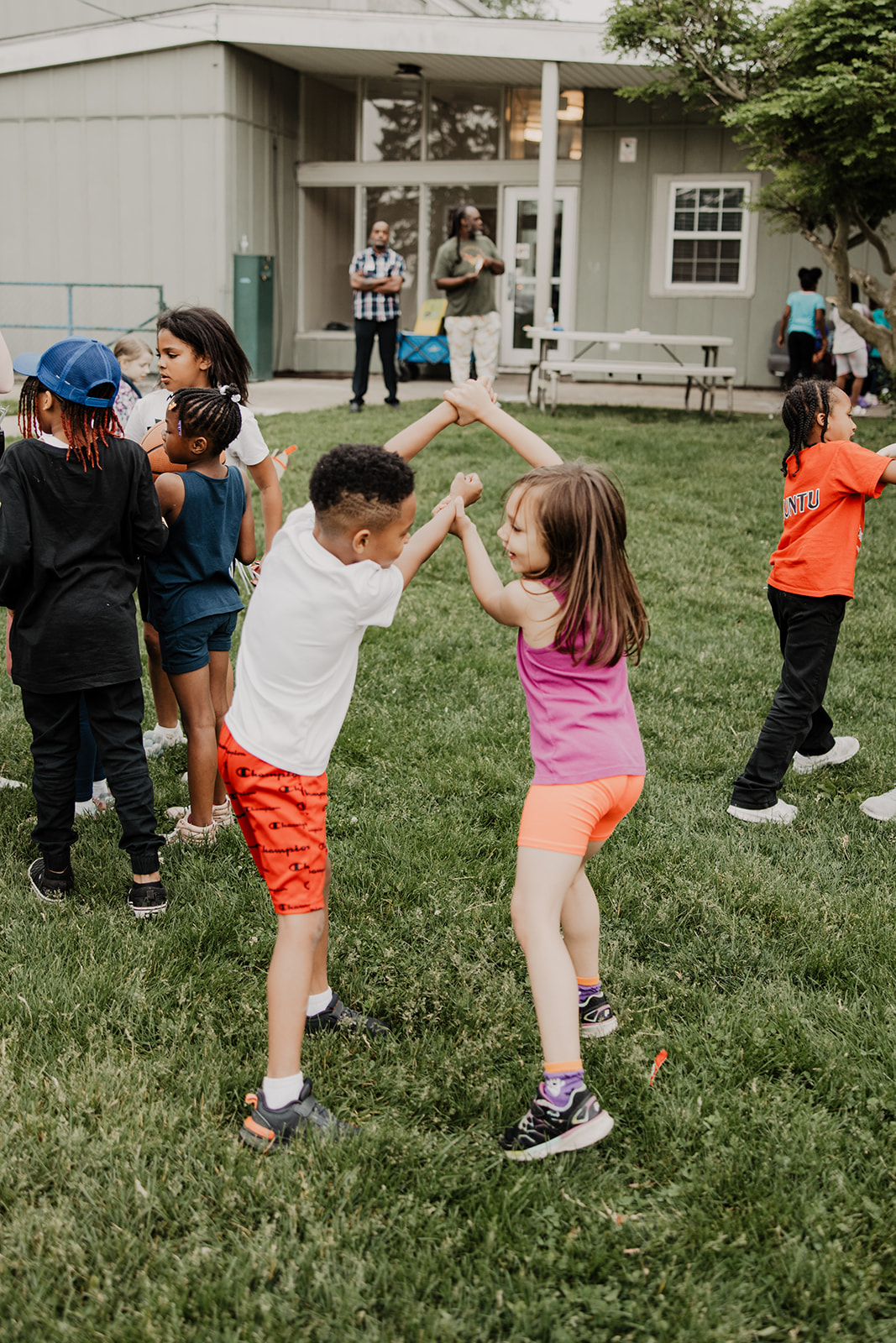 Child play outdoor game holding hands. Boys & Girls Club of Bloomington-Normal.