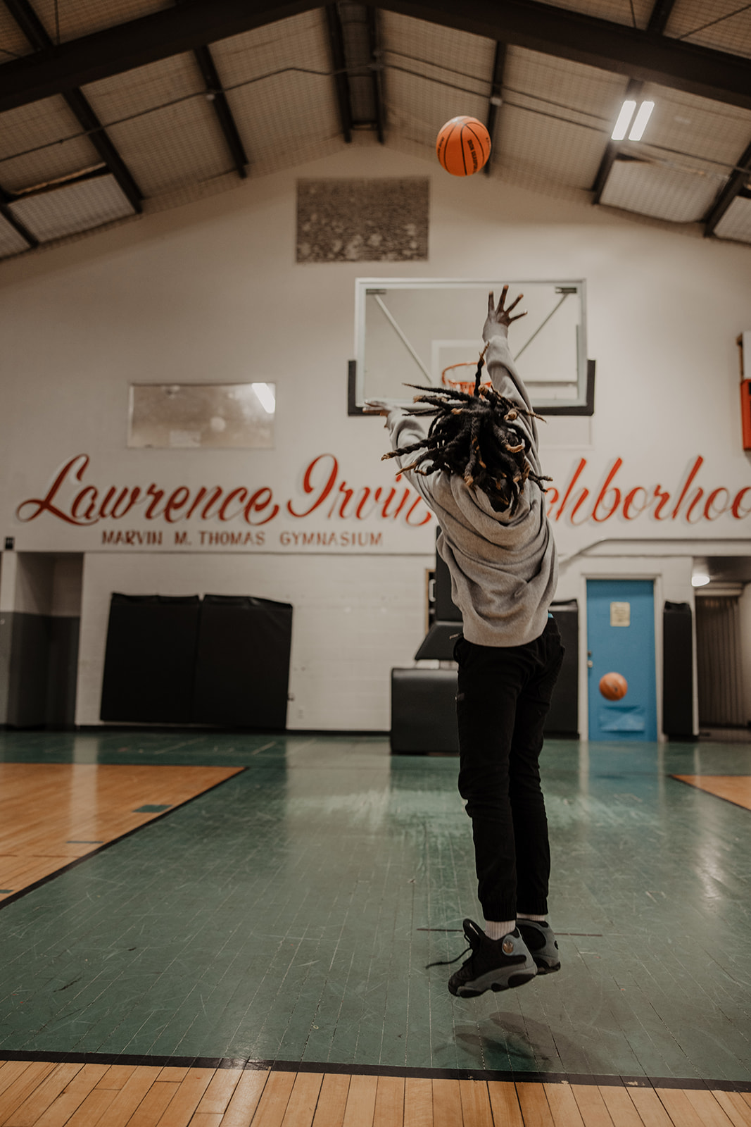 Boy shoots a basketball toward the hoop at Boys & Girls Club of Bloomington-Normal.